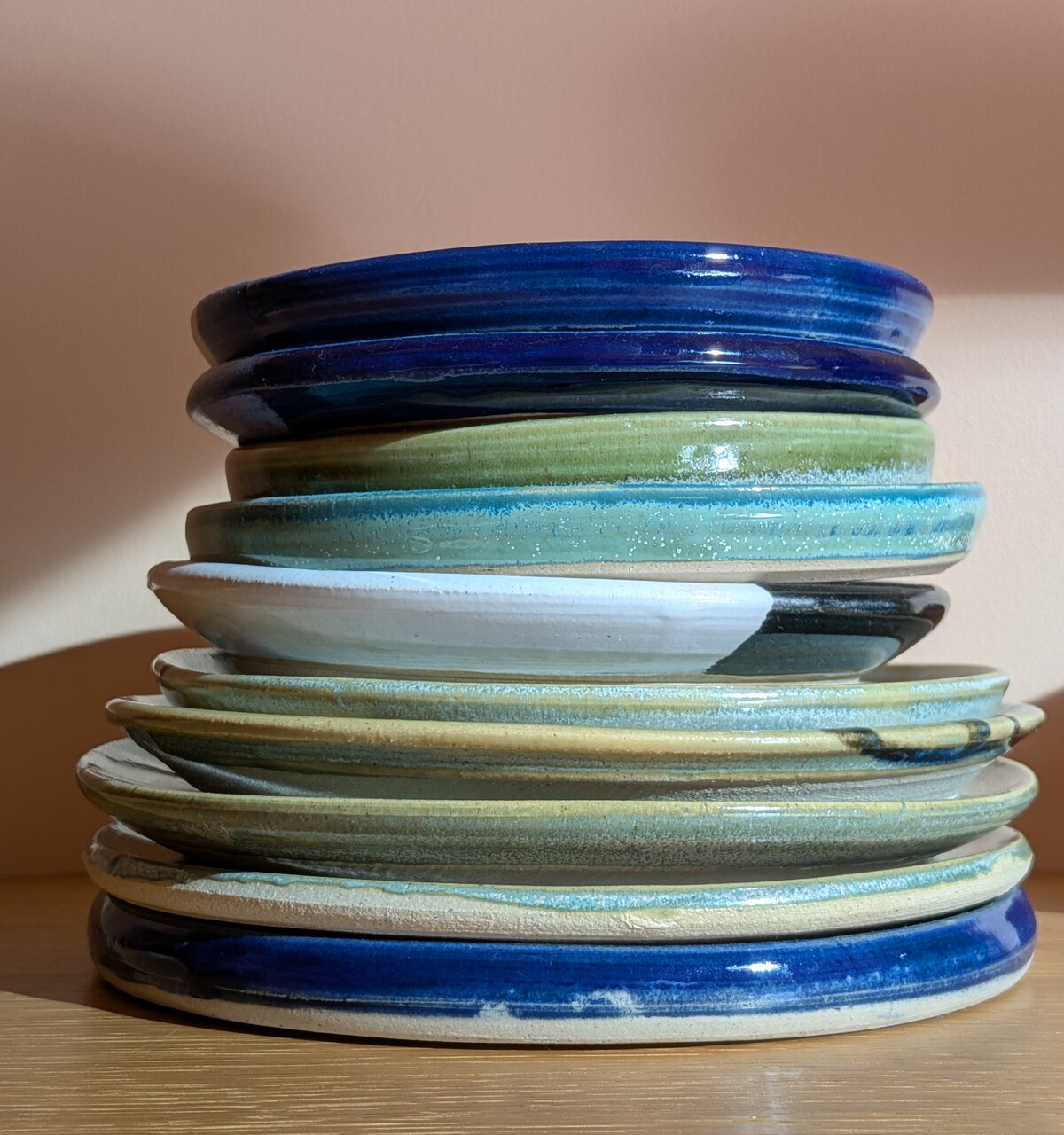 A stack of colourful glazed ceramic plates